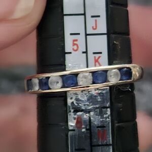 10k white gold with round sapphire and diamond like stones. 6.5 size